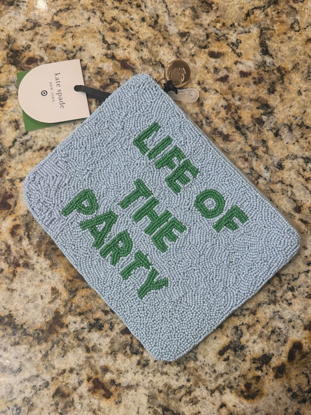 kate spade light blue beaded pouch with green lettering